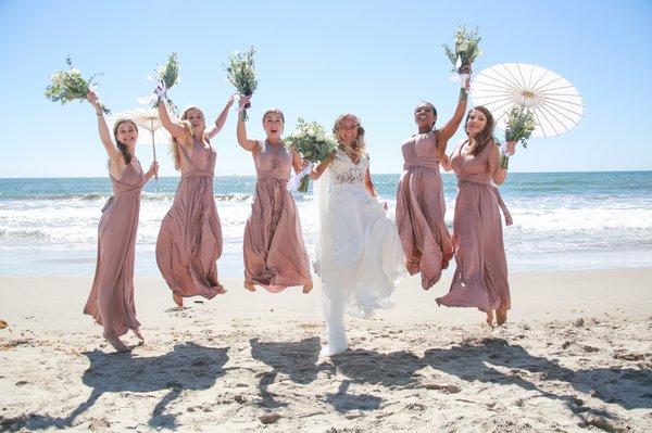 Bridal party having fun on the brides' wedding day on the beach!