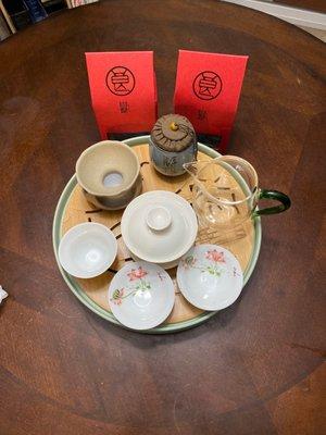 Raw and aged pu'er tea on a traditional tea tray for tea serving