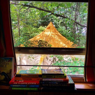 The office and guest library. A Lotus Belle tent is outside the window.