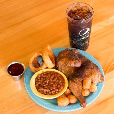 Half Chicken Plate with Onion Rings and BBQ Beans.