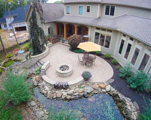 An outdoor retreat for multi-level entertaining, offers a water feature and fire pit.