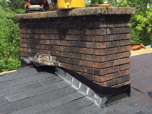 Now we install the new step flashing. One piece of metal flashing per line of shingle