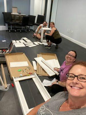 The crew puts together furniture pre-opening.