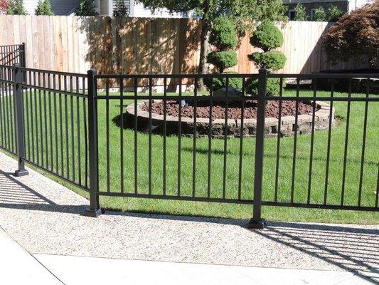 Aluminum fence on plates mounted to concrete patio,