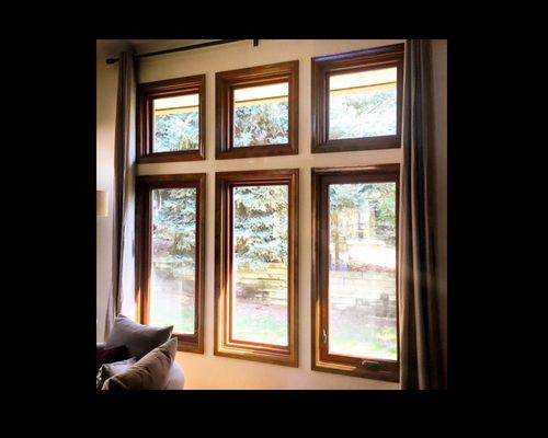 Wood windows? Think again! These are vinyl windows with a wood grain laminate interior and a very satisfied customer