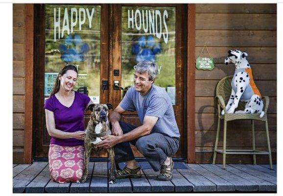 Owners in front of Happy Hounds Pet Supply storefront