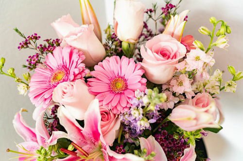 Wax flower and lilies with roses