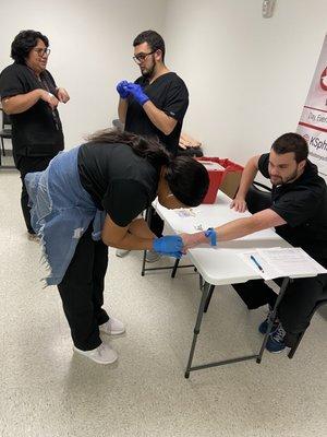 Students practicing their butterfly draw technique .