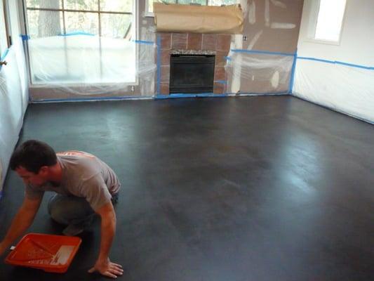 A concrete Microtopping installed over an existing worn down floor. We added 3 stain colors to the topping and sealed it.