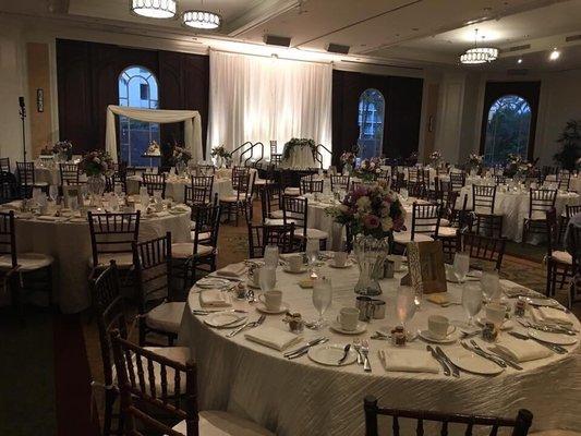 Our beautiful ballroom! Chiavari chairs, table cloths, napkins, sweetheart table linen, suspended wedding cake and back drop all from REA