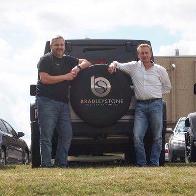 Owner Brad and VP Kevin with the Bradley Stone Industries logo.