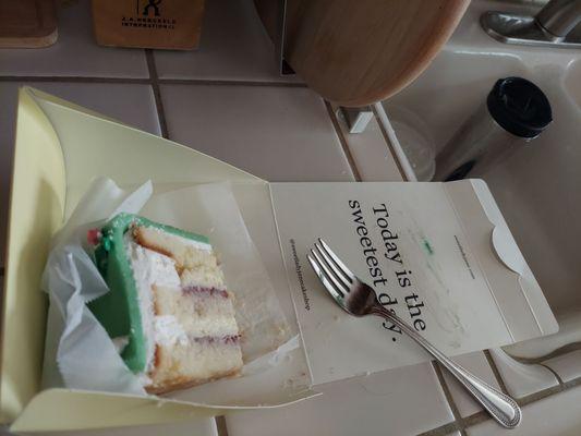 Princess cake with piece eaten.