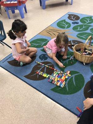 PreK students sorting Legos by size!