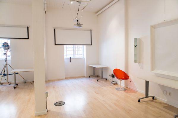 The Studio is a large, bright, space with 2 projector screens.