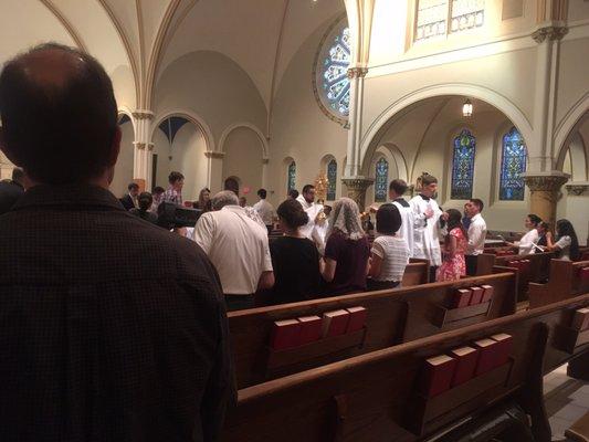 The Blessed Sacrament is incensed at the start of a procession from St Thomas the Apostle on Corpus Christi.