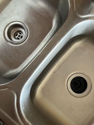 b. Stromberg installed new kitchen sink basket strainers. One is silver (left) and the other is black (right). Why not match?