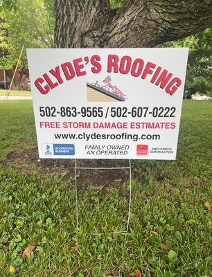 Image of Clyde's Bluegrass Roofing yard sign in a satisfied customers yard. After, the completion of their new roof!