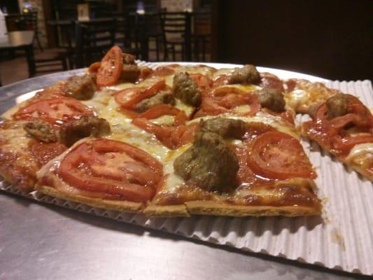 Thin crust Sausage and pepperoni pizza.