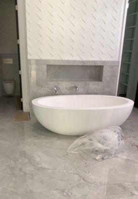 Bathtub and faucet installed in new bathroom remodel