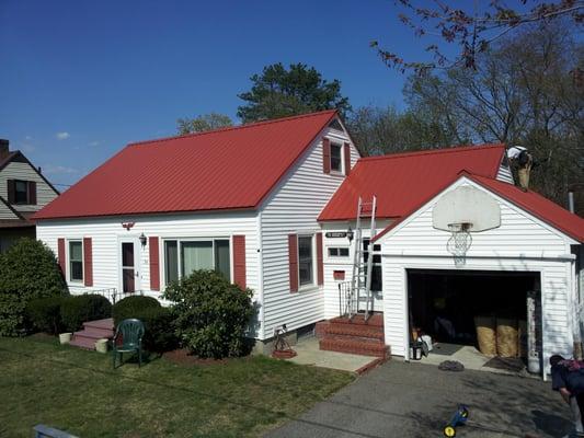 For this beautiful cape with attached garage, we chose to go with ABC Imperial Rib metal roofing...