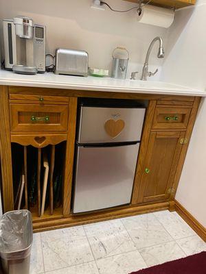 Lower Oak Cabinet w/Tray Rack, Cutting Board, S/Steel Fridge w/Freezer, Toaster, and Keurig Coffeemaker o/ Carrera Marble Floor