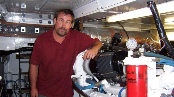 Mike Patterson at home in the  engine room of the 86' Elliot sportfisher "Madrugador" while installing a hydraulic pump and system.