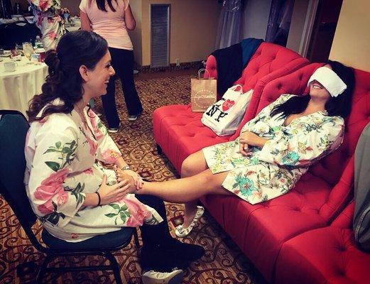 Lisa, owner of OPTM, giving the bride a foot massage before her wedding.