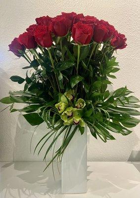 24 Long stemmed roses & cymbidium orchids. To place an order call (949)464-0509 or visit https://lagunabeachflorist.com .