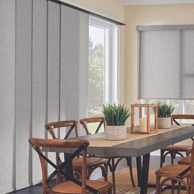 Motorized panel track and roller shades. Call for a free consultation today.