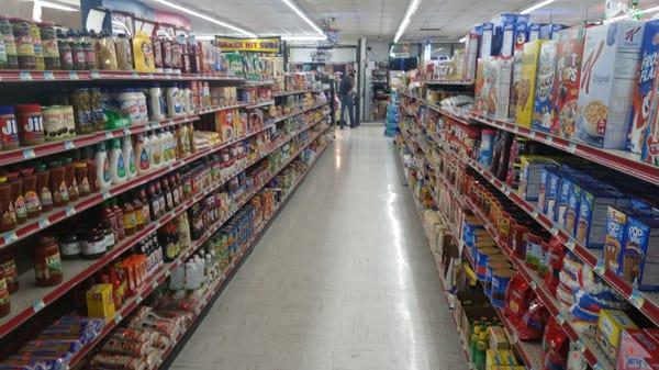 Aisle stocked full of grocery items.