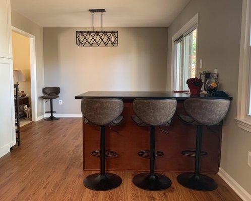 Breakfast bar in place of non-load bearing wall, counter overhang extended on kitchen side, storage drawers on dining room side (next photo)