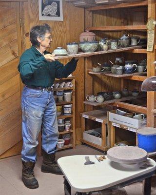 Julie Dickinson removing finished pots from the rack