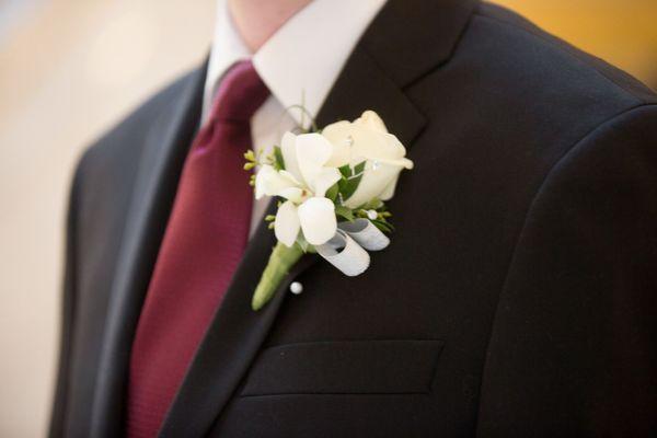 White rose and orchid boutonniere