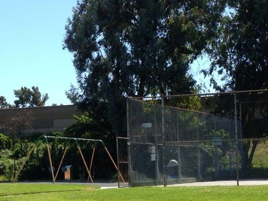 Swings & fenced in basketball court