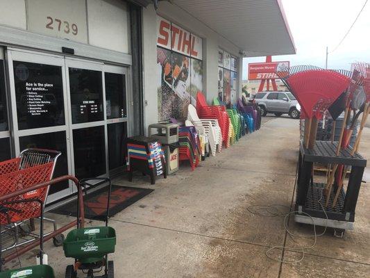 Chairs and garden tools out front