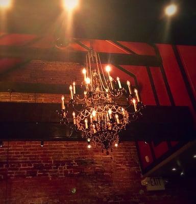 Beautiful intricate chandelier drops from wood beams and exposed ceiling. Lovely atmosphere and ambiance!