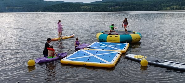 Trampolines docks kayaks paddleboards family fun time on the water .