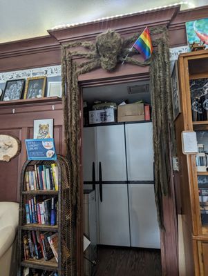 The large LGBTQIA+ support spider over the entry to the bathroom