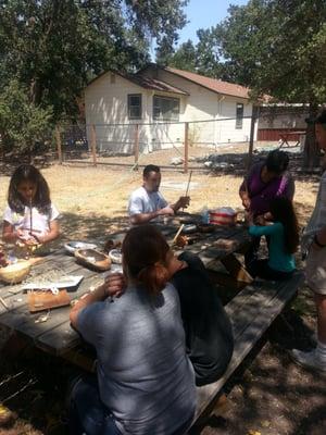 Making jewelry with primitive tools, our volunteer station