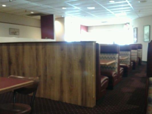 Sitting in a booth and waiting for dinner.