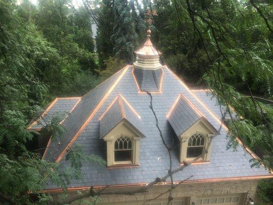 New slate roof with custom copper weather vain.