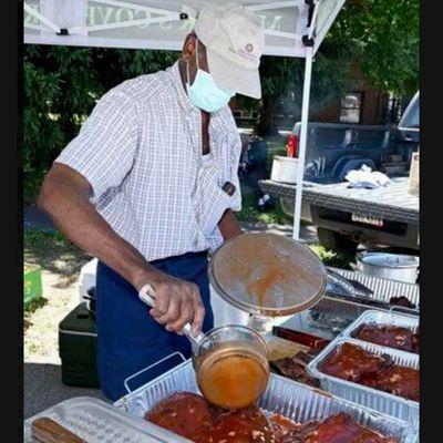 Stephen Miller saucing our famous ribs.