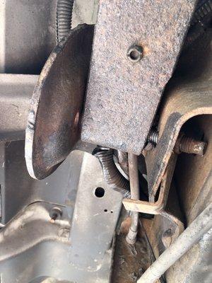 Sheared leaf spring mounting bolt