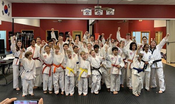 Color Belt Students showing victory after a belt promotion event