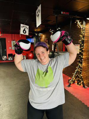 9ROUND Kickboxing Fitness Member "BoneCrusher" proudly flexing for #FlexFriday after crushing her killer workout. She looks happy to be done