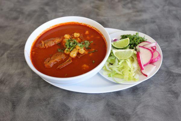 pozole de puerco servido con lechuga, rabanos, cebolla y limon.    Tortillas hechas a mano o tostadas.