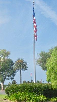 Olmsted Place flag with Memorial Garden flag in the background