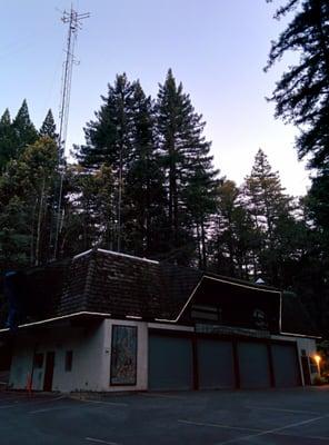 Cute little fire house and community center located in the trees.