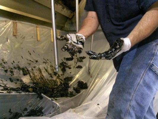 Pulling grease out of a poorly maintained exhaust hood.