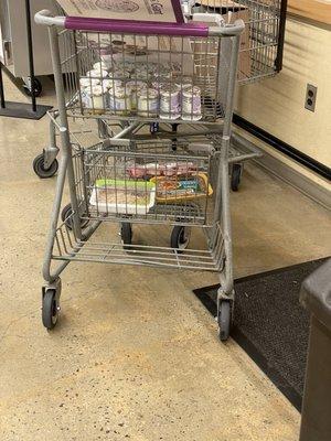 Yogurts and meats just sitting in a cart. Where wil they go? Trash or back in the fridges?